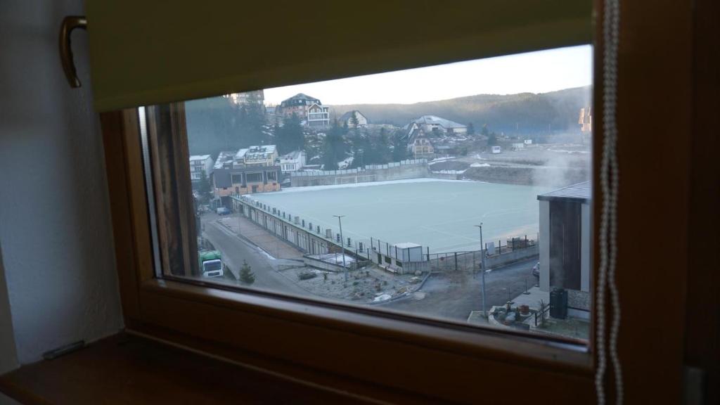 a window with a view of a body of water at Apartmani Flocke Vlašić in Šišava
