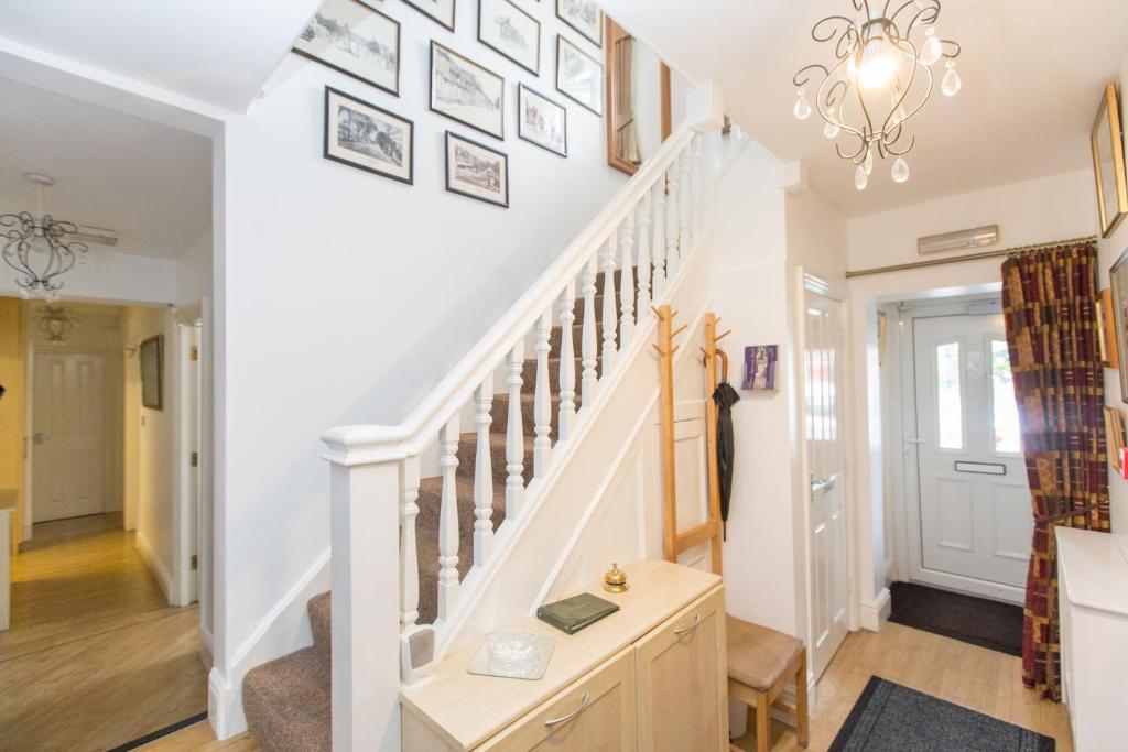 a staircase in a home with pictures on the wall at Station Approach in Solihull