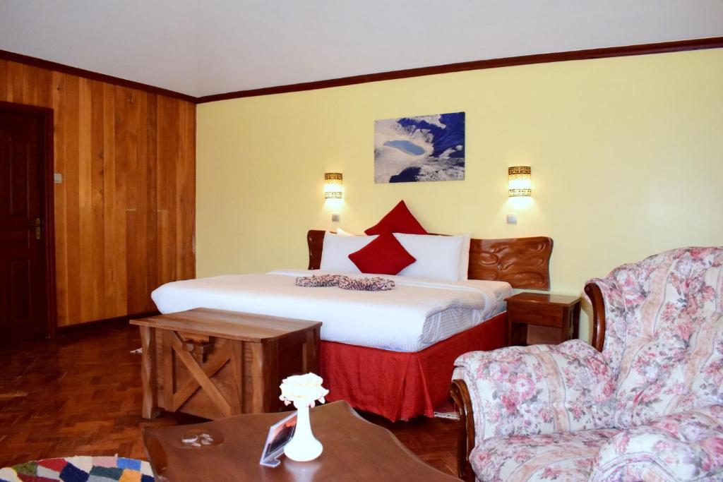 En eller flere senge i et værelse på The Nelion