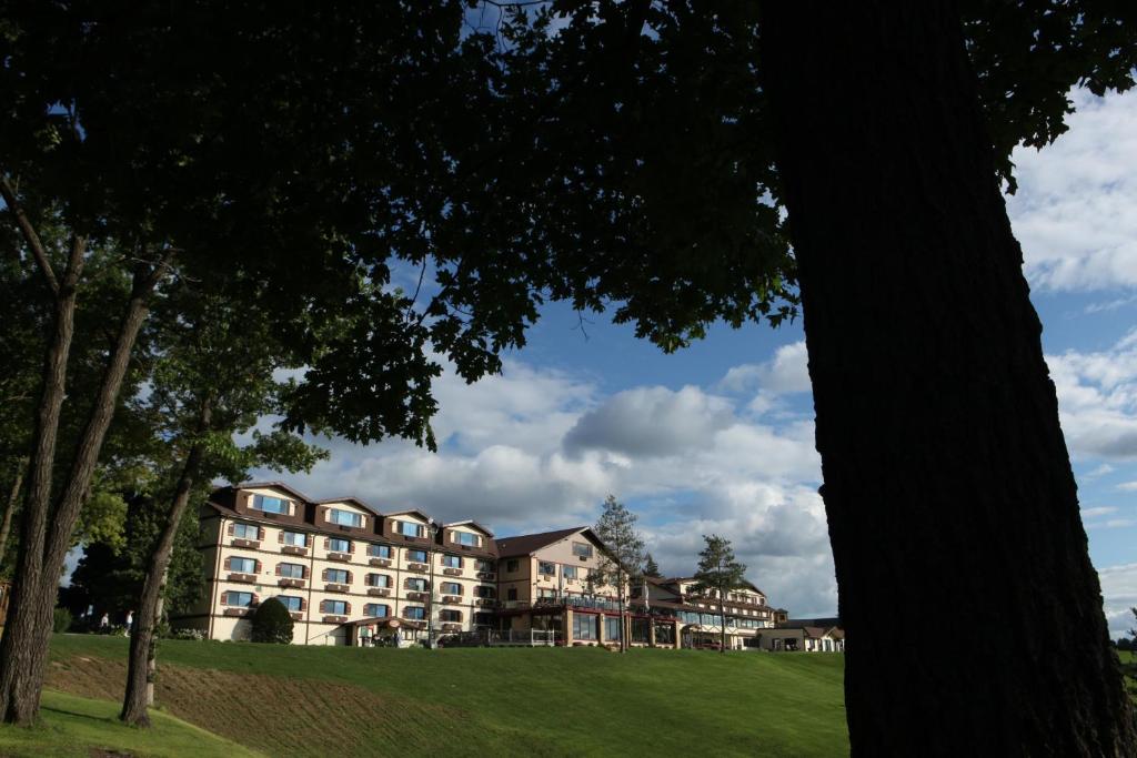 a building on a hill with trees in the foreground at Chestnut Mountain Resort in Galena