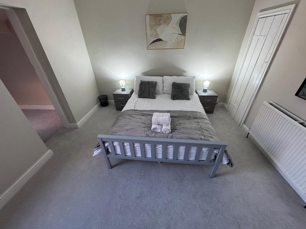 a bedroom with a large bed and two night stands at 25 Birks Road in Cleator Moor