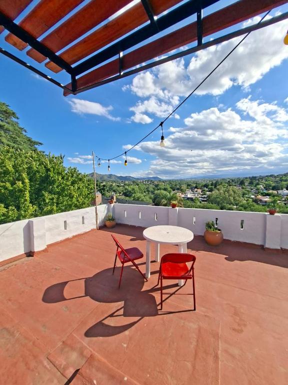 a patio with two chairs and a table on a roof at Cielo Serrano VCP in Villa Carlos Paz