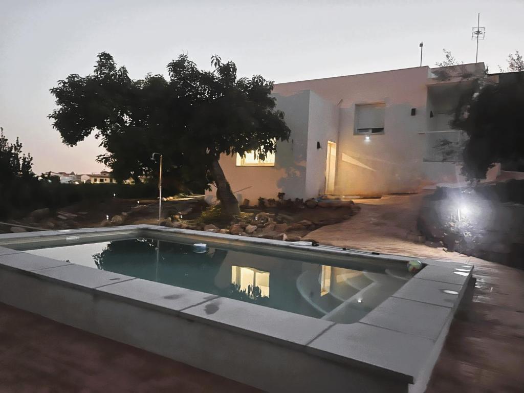 a swimming pool in front of a house at Villa Verzul in Lobres