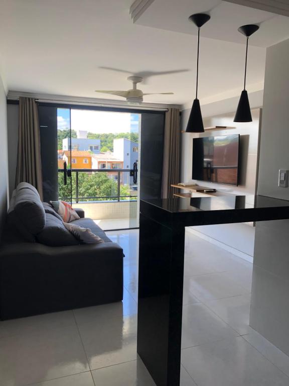 a living room with a couch and a table at Apartamento Piúma in Piúma