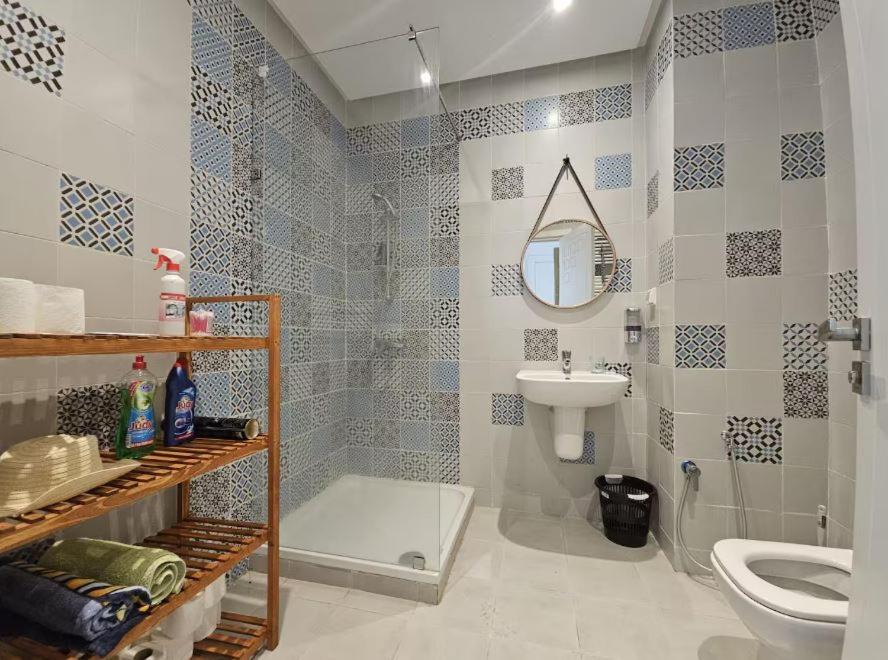 a bathroom with a sink and a toilet and a mirror at bel appartement wifak 5min de stade de rabat in Temara