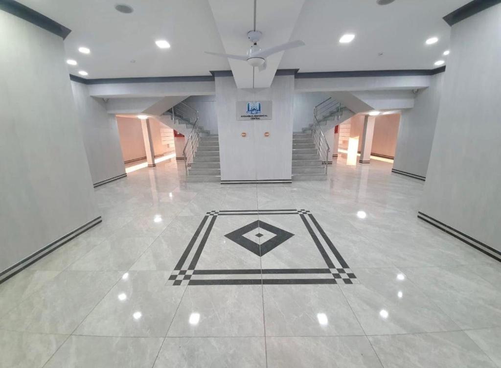 a hallway with a tile floor with a geometric pattern on it at Apartament Vâlcea in Valcea