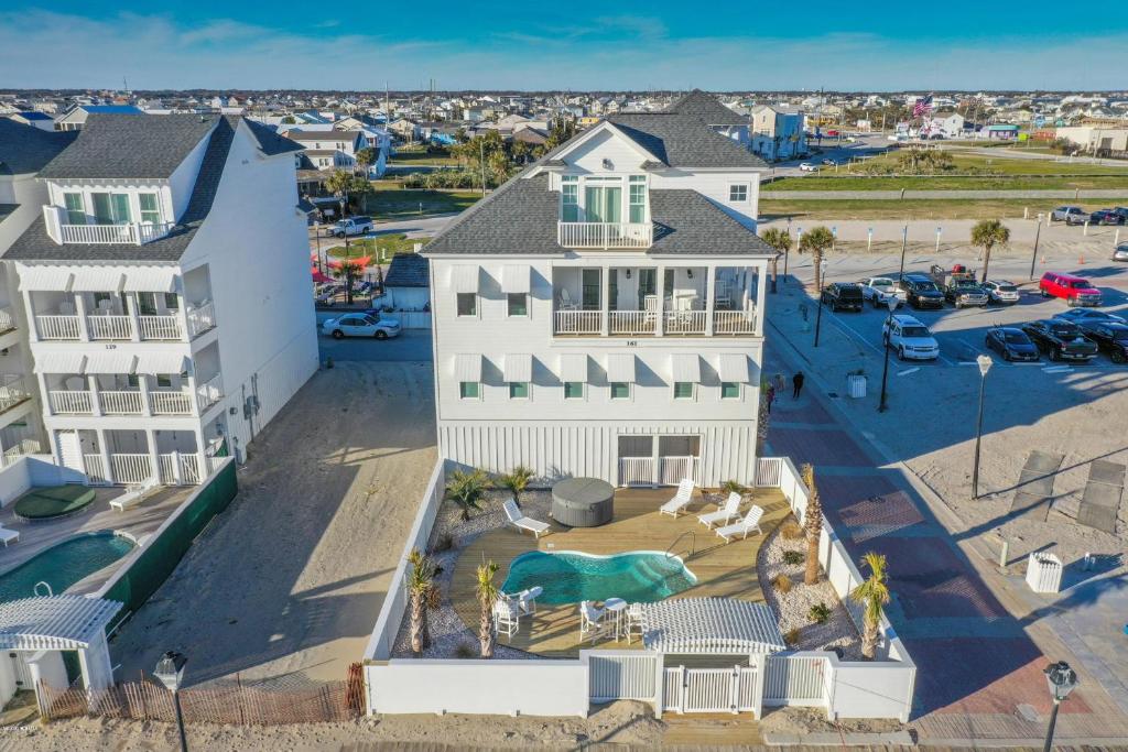 an aerial view of a white house with a yard at Captain's Choice in Atlantic Beach