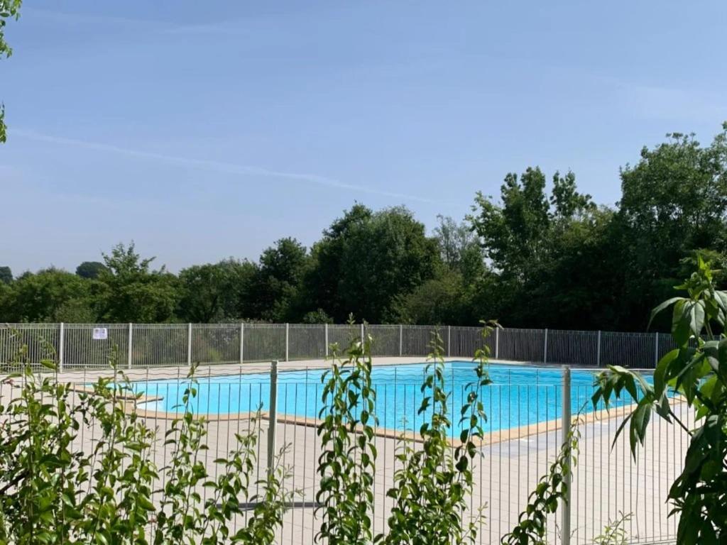 a swimming pool behind a fence at ZEcamping 3 étoiles animaux acceptés piscine snack bar et restaurant in Moutiers-sous-Chantemerle
