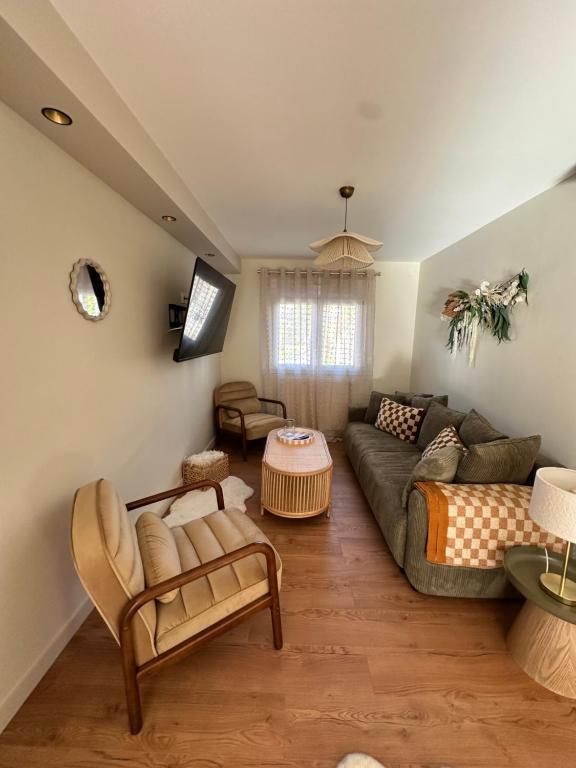 a living room with a couch and a table at L'écrin du sancy in La Bourboule