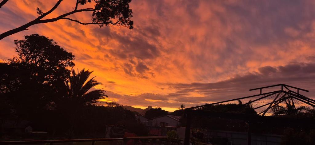 a sunset with an orange and red sky at Hidden gem cheap and affordable in Te Kopuru
