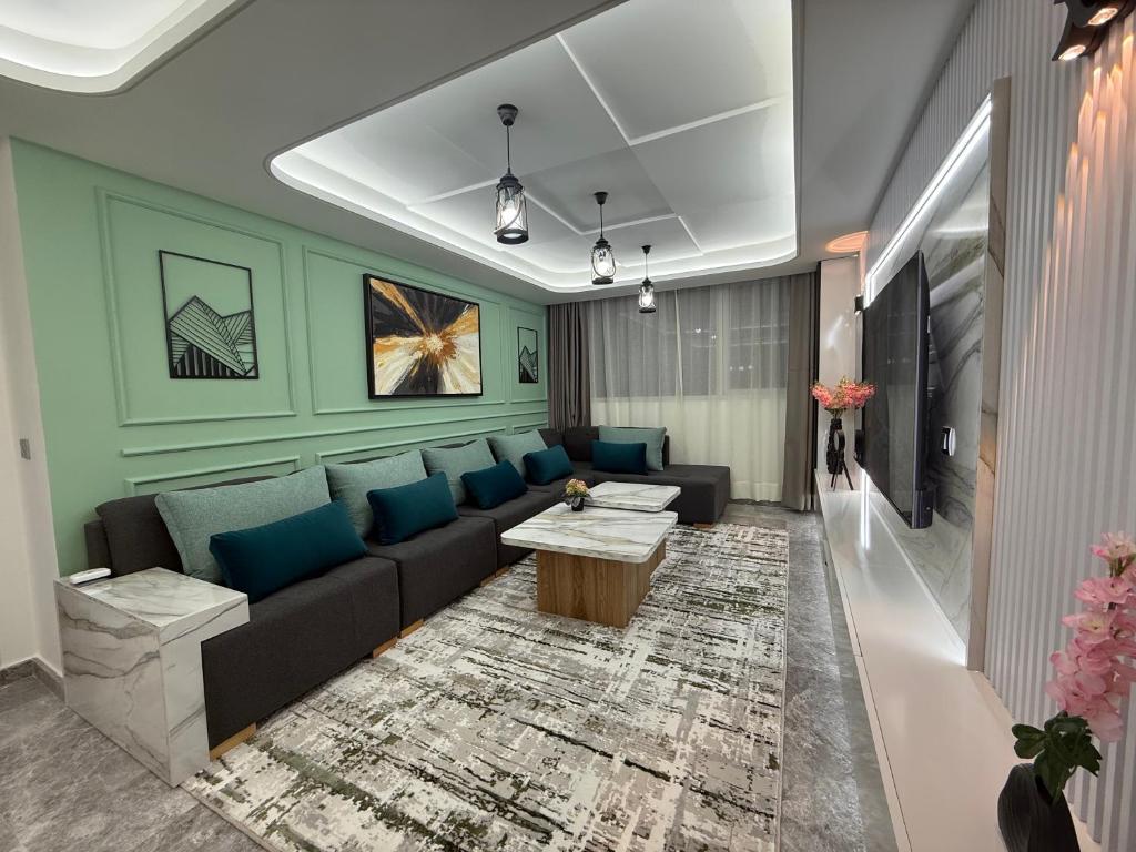a living room with a couch and a table at Hilton View Tower Residency Apartment Tanger Partial Sea View in Tangier
