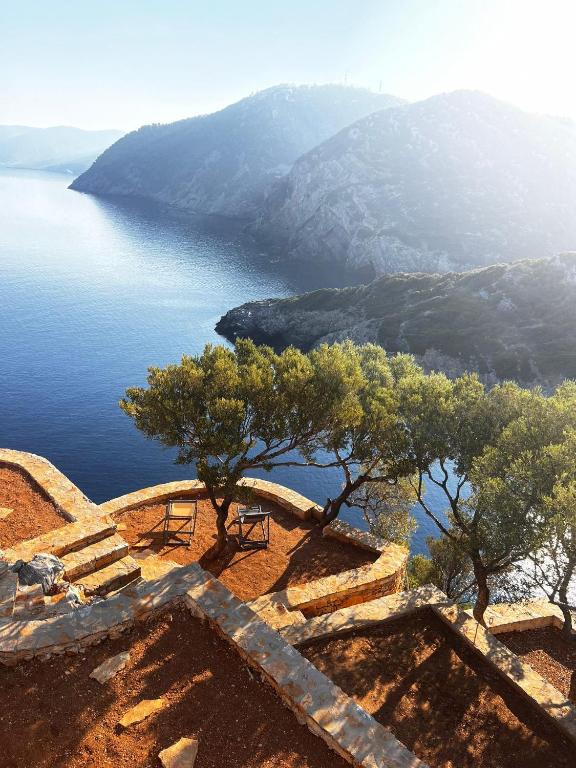 a view of the ocean with trees on a hill at Casa Milos Aegean Suites in Alonnisos