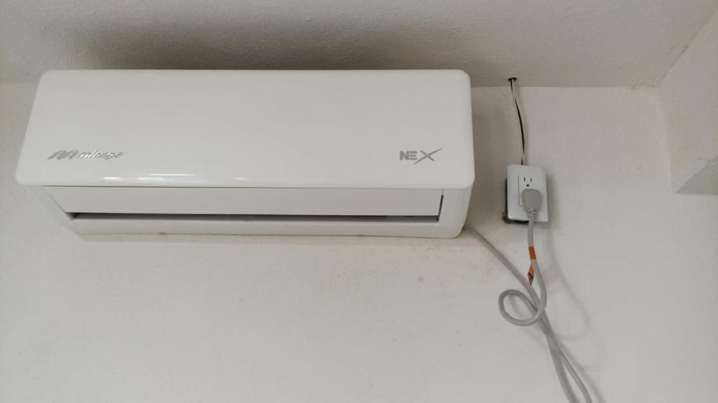 a white printer sitting on a counter with a pair of scissors at Casa alexander in Acapulco