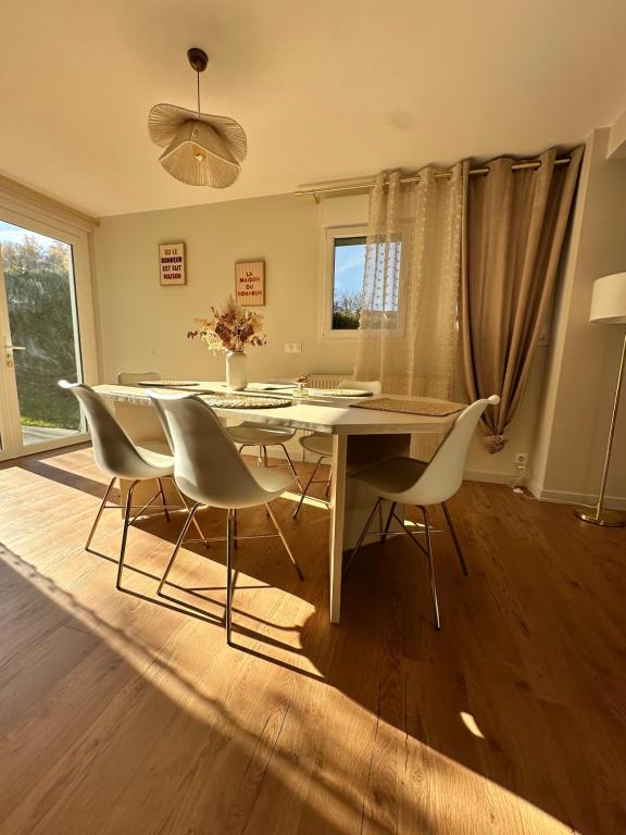 a dining room with a table and chairs at L'écrin du sancy in La Bourboule