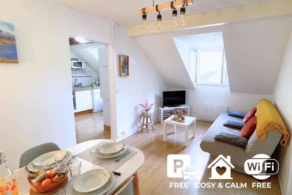 a living room with a couch and a table at Gîte cosy et paisible près de La Mongie in Campan