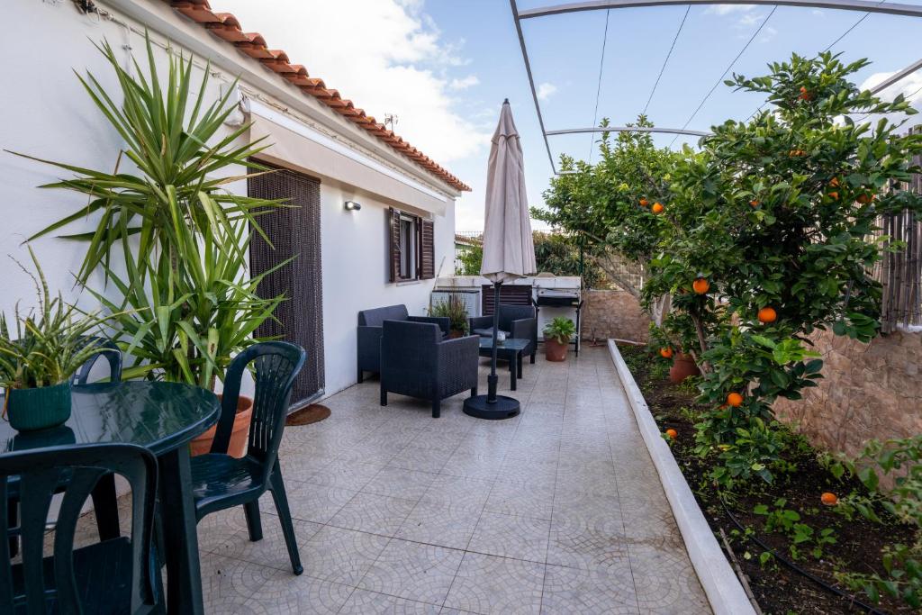 an outdoor patio with tables and chairs and orange trees at Cantinho Alentejano-Rua das Hortas, Corte Pao e Agua in Mértola