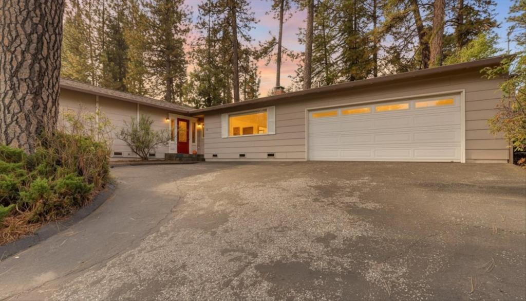 a house with two garage doors and a driveway at Gold rush nook in Grass Valley