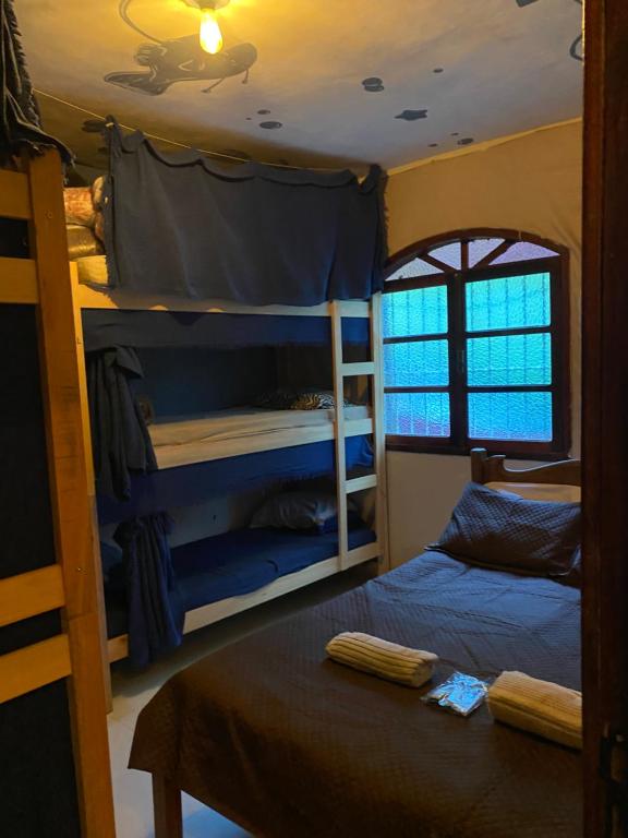 Een bed of bedden in een kamer bij Green House Chalé, hostel e pousada