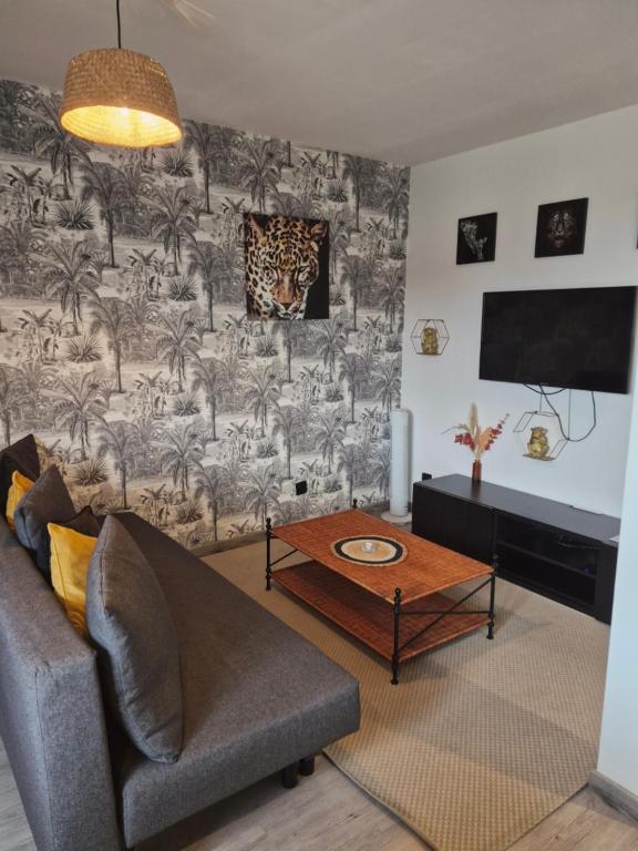 ein Wohnzimmer mit Sofa und Tisch in der Unterkunft Cosy Loft - Appartement de charme in Marsannay-la-Côte