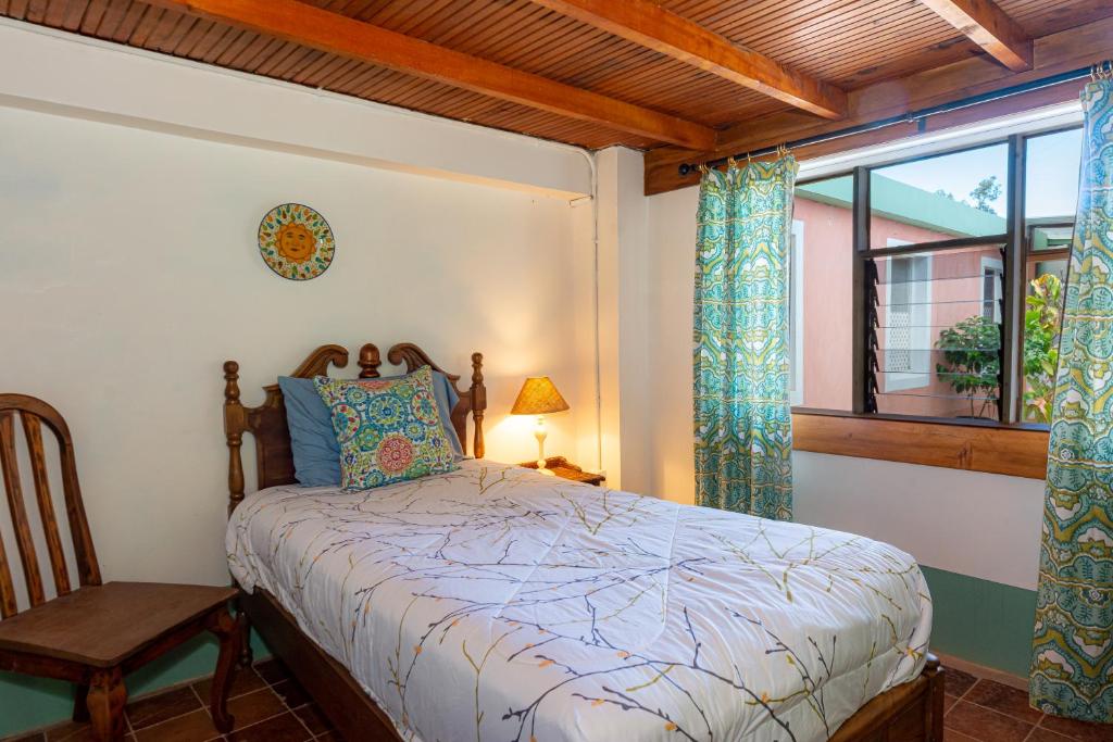 a bedroom with a bed and a window at Bhoga Forest 