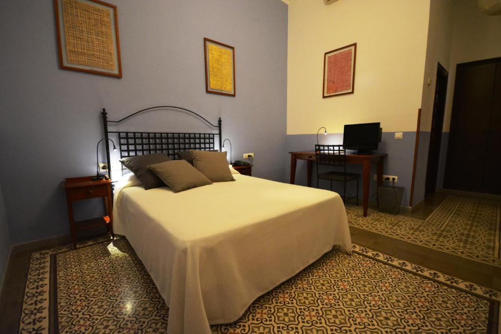 Postel nebo postele na pokoji v ubytování Hotel Casa de los Azulejos