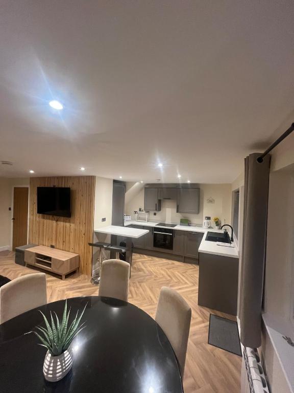 a kitchen and dining room with a black table and chairs at Caledonian Lock House in Caol