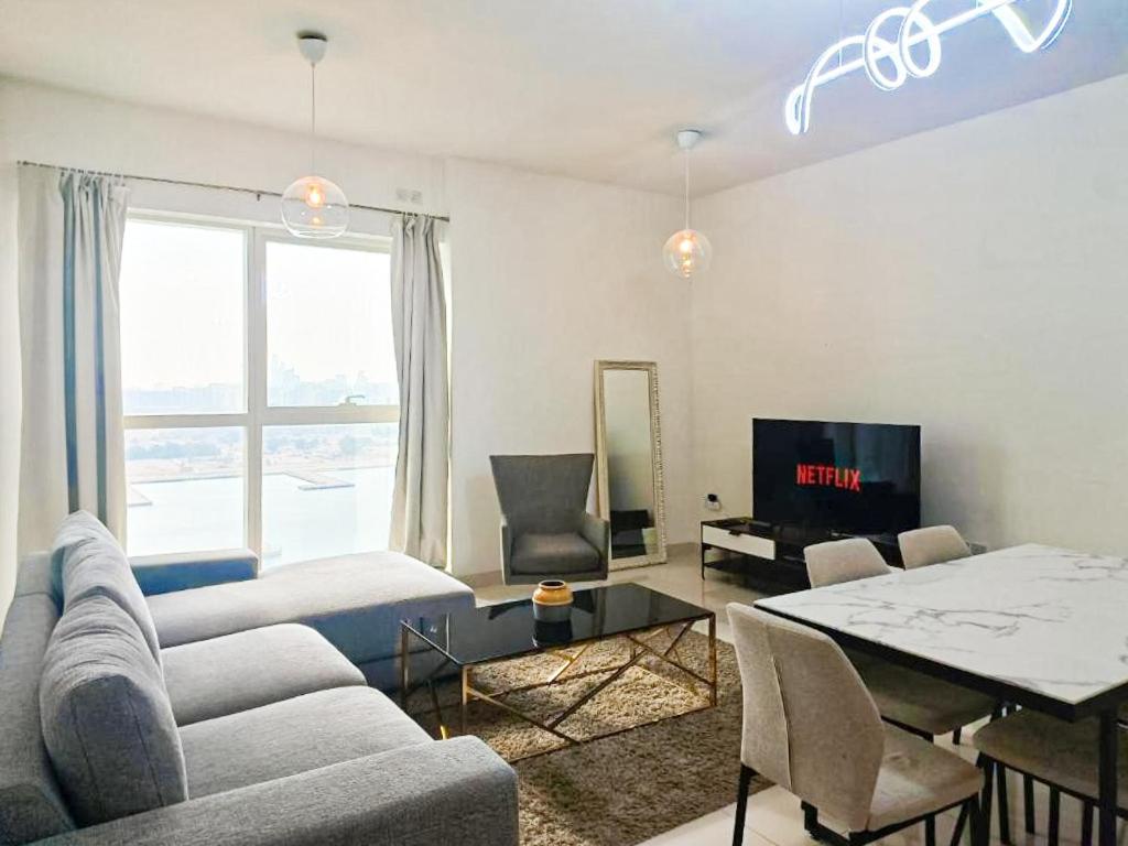 a living room with a couch and a table at Exclusive Sea-View 2BR Apartment with Fireworks View in New-year eve in Abu Dhabi