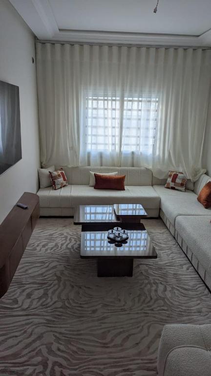a living room with a couch and a table at NAYA apartment in Fez