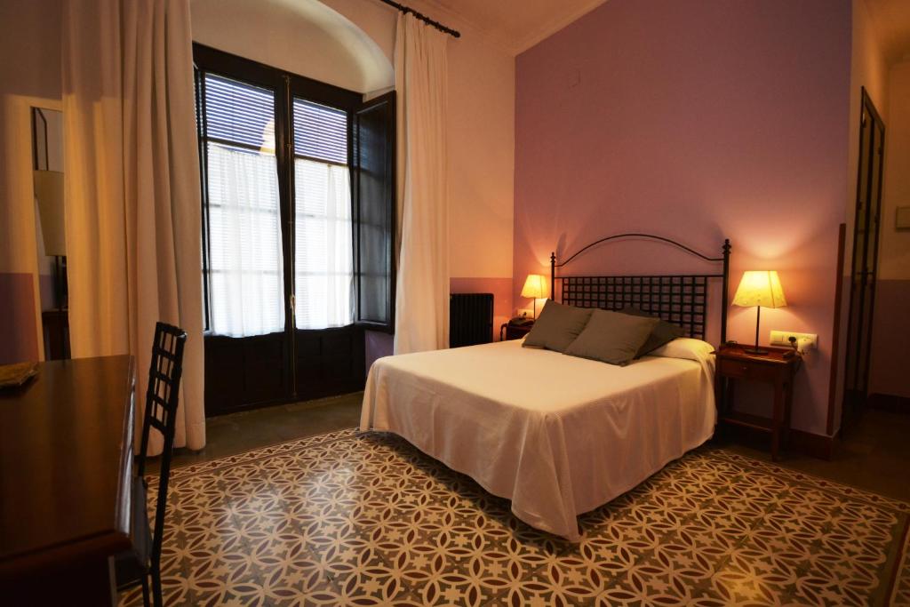 En eller flere senge i et værelse på Hotel Casa de los Azulejos