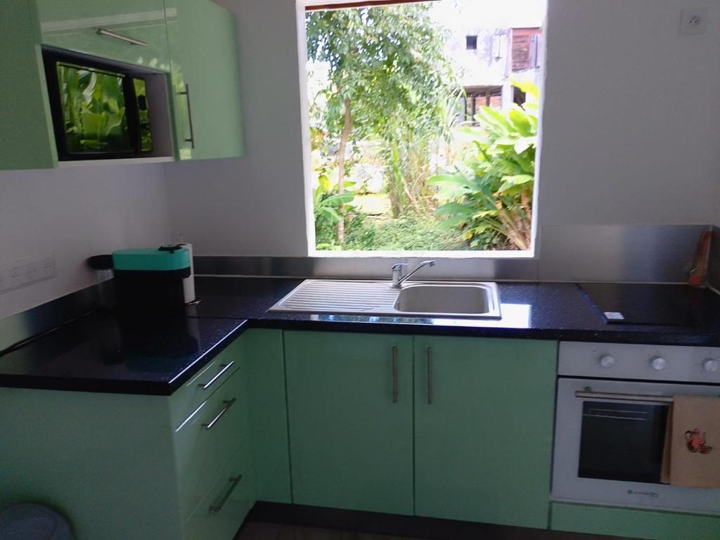 a kitchen with a sink and a window at Brada Gites2 in Deshaies