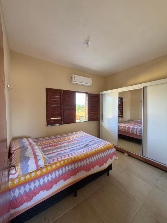 een slaapkamer met een bed en een grote spiegel bij Casa da Duna Moitas-Icaraizinho de Amontada Ceará in Praia de Moitas