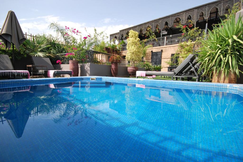 a large blue swimming pool on top of a building at Riad Terra Bahia in Marrakesh