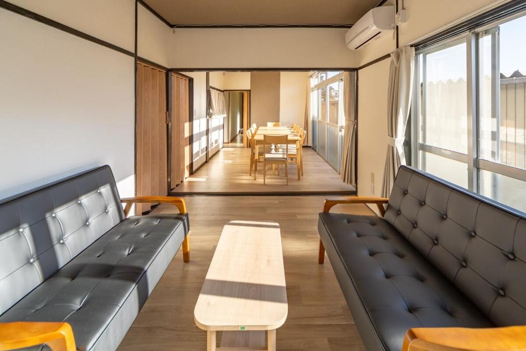 a room with benches and a table and a dining room at FUJIMI Place in Yamanashi