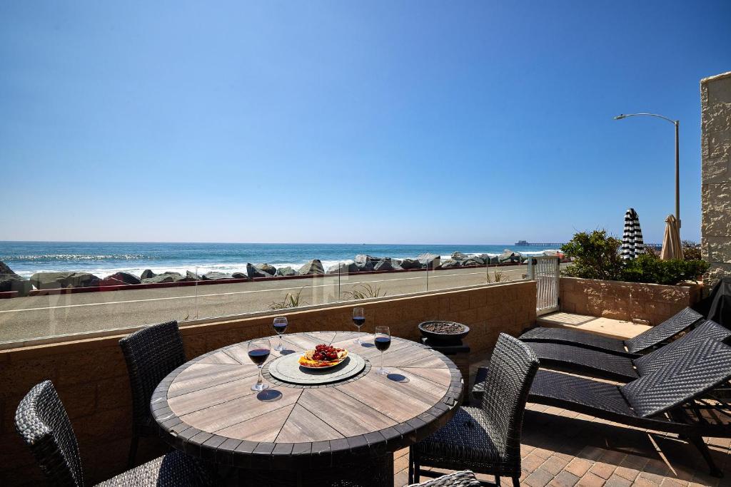 a table and chairs on a balcony with the beach at 700-104 Water Front Condo w AC in Oceanside
