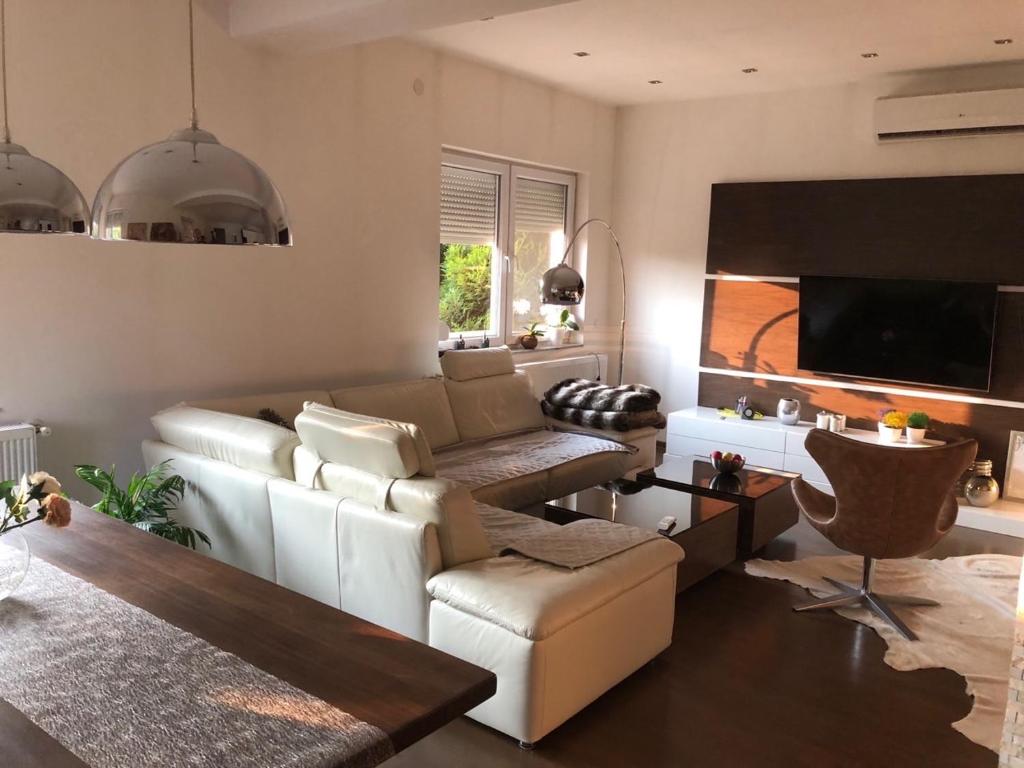 a living room with a couch and a tv at NOVA residence in Sarajevo