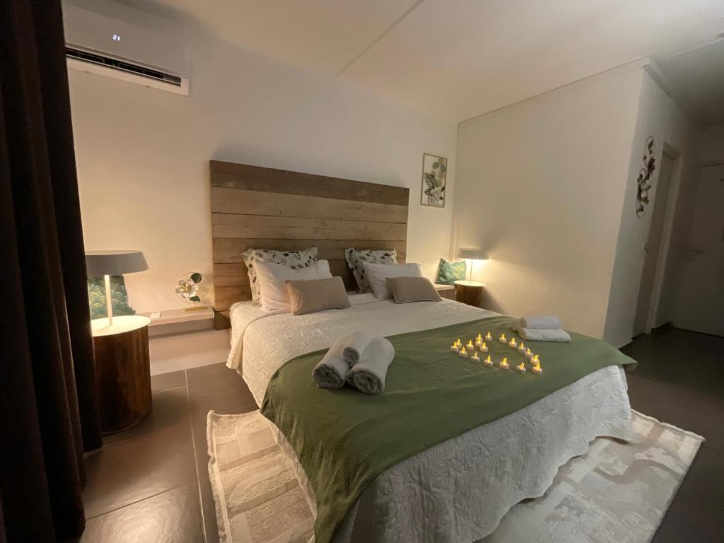 a bedroom with a large bed with towels on it at Studio Les Marines V - calme - vue sur le golf in Saint-François