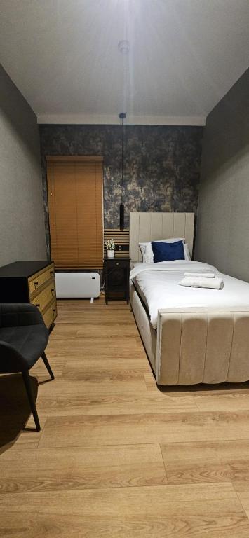a bedroom with a large bed and a desk at Amber Single Room17 Self Check-In Accommodation in Hull
