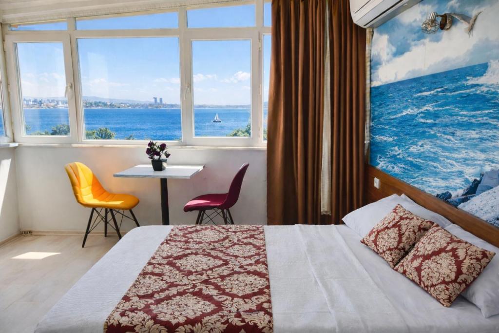a bedroom with a bed and a table with chairs at Sultanahmet Center View Apart Hotel in Istanbul