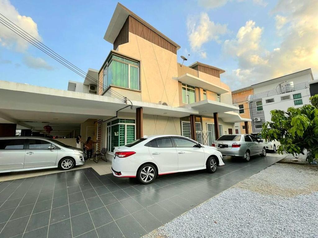 three cars parked in a parking lot in front of a house at 1091 LUX Conner in Port Dickson