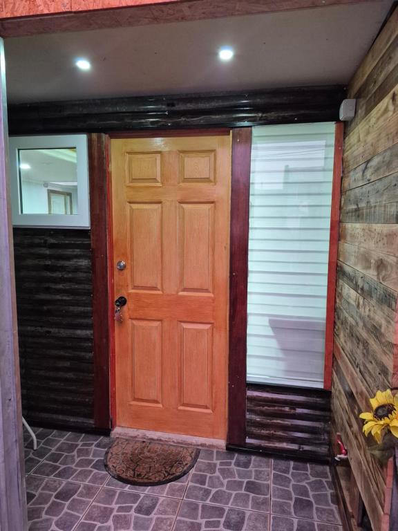 an empty garage with a wooden door at Departamentos H&G in Punta Arenas
