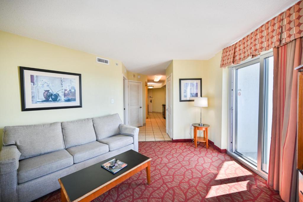 a living room with a couch and a table at Beachfront Condo with Stunning View Multiple Pools on BV 7th Floor in Myrtle Beach
