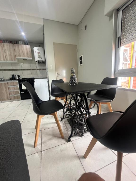 a room with a table and chairs in a kitchen at SJ Apart in Corrientes