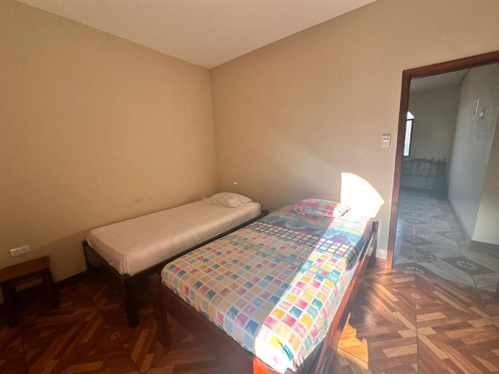a small bedroom with a bed and a lamp at Hostal Luxury Place in Bahía de Caráquez