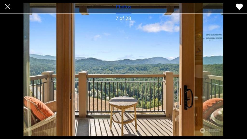 a balcony with a chair and a view of the mountains at Suncadia Lodge in Cle Elum