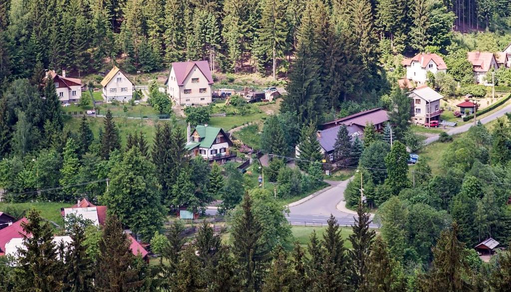 a village in the mountains with a road and houses at Chata Barborka in Horní Bečva