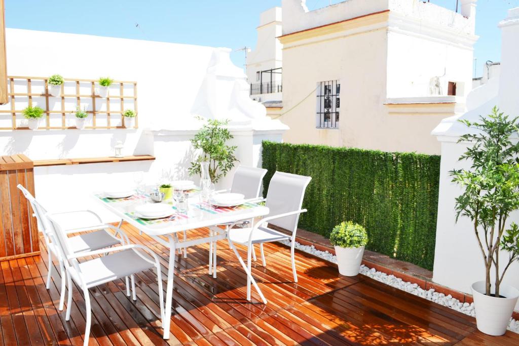 patio con mesa y sillas en el balcón en Ático Fenicia, en Cádiz