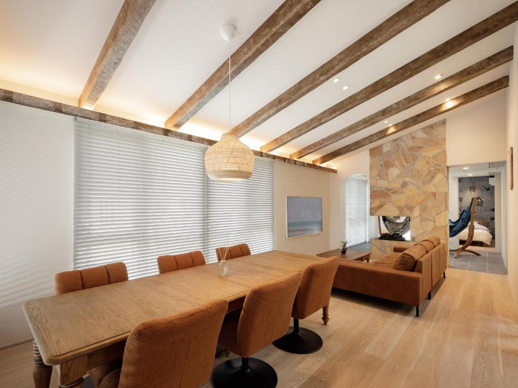 a dining room with a large wooden table and chairs at -new-SHELL THE THIRD in Kamakura
