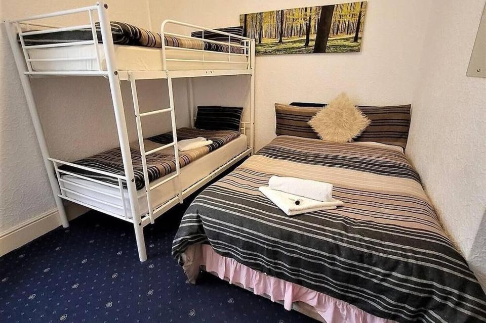 a room with two bunk beds and a ladder at Holiday Plus - 50 Palatine Road in Blackpool