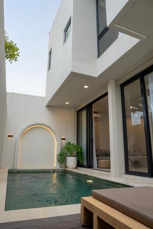 an external view of a house with a swimming pool at Kaiarasa Villas and Suite in Canggu