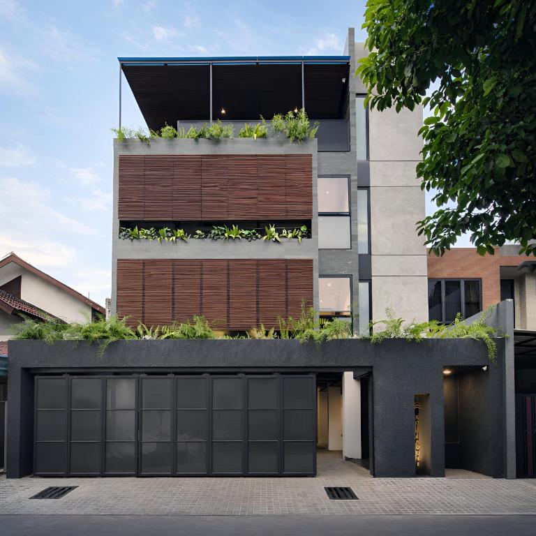a building with plants on top of it at Koji House in Jakarta
